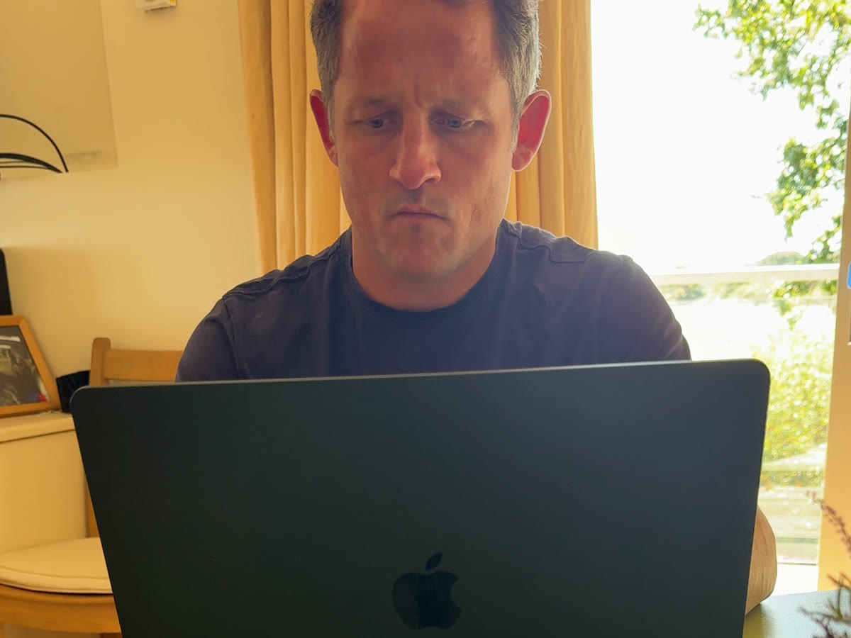 Dicky working at his laptop